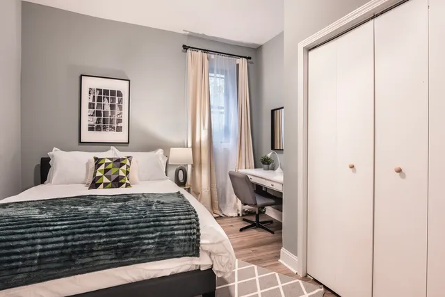 a bedroom with a bed and a window