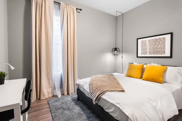 a bedroom with a bed and a window