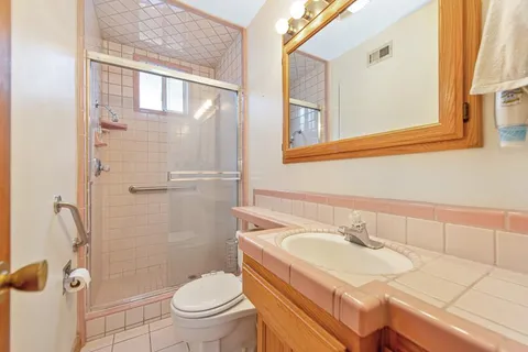 a bathroom with a sink toilet and shower