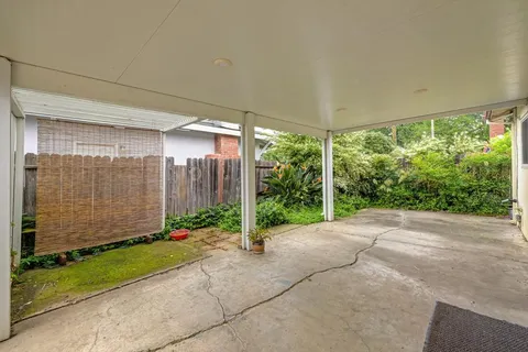 a view of backyard with plants and outdoor seating