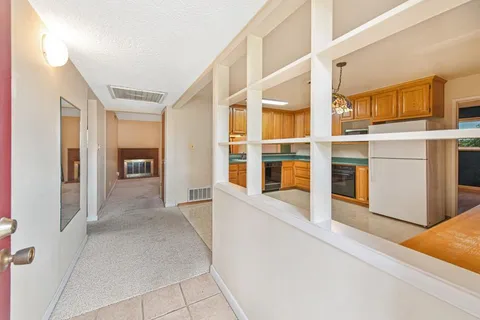 a view of an entryway with wooden floor and a cabinet