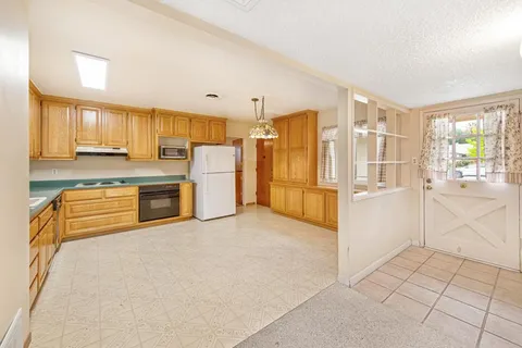 a kitchen with stainless steel appliances a refrigerator and cabinets
