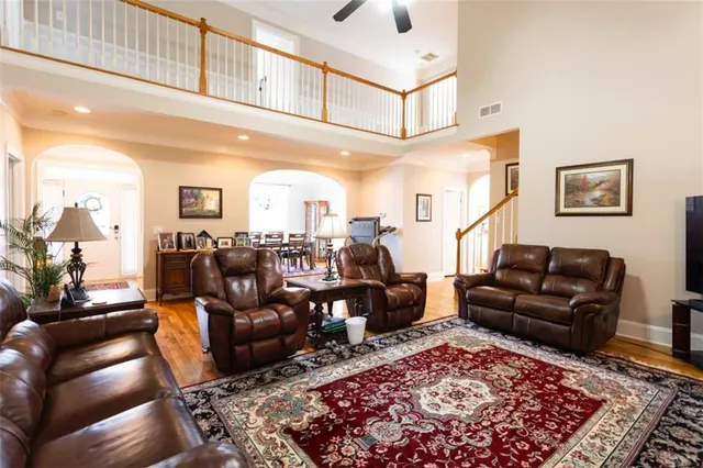 a kitchen with stainless steel appliances granite countertop a stove a sink dishwasher and a refrigerator with wooden floor