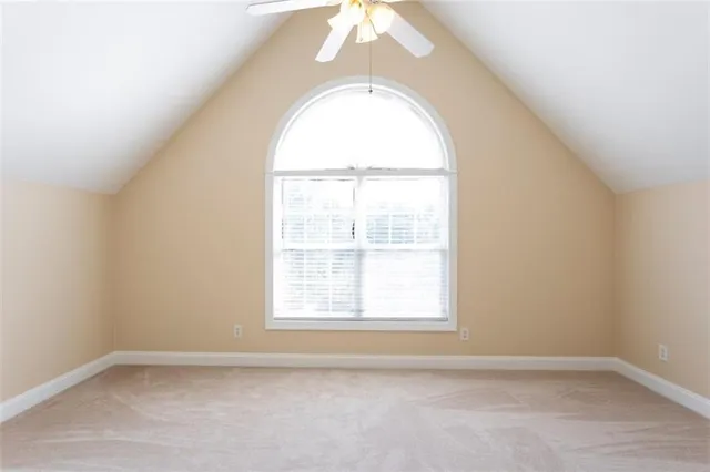 an aerial view of a house with swimming pool and large trees