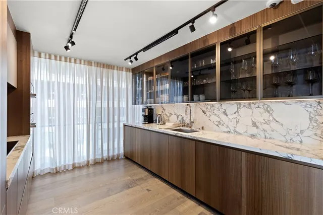 a view of kitchen with a sink and cabinets