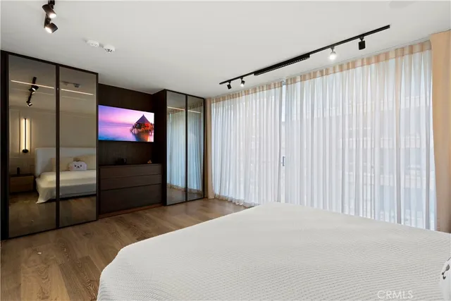 a bedroom with a bed and a flat screen tv