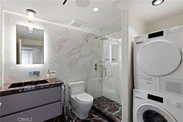 a bathroom with a toilet a sink and a mirror