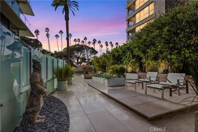 a view of a patio with couches and table and chairs and potted plants