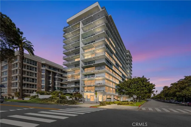 a view of a tall building next to a road
