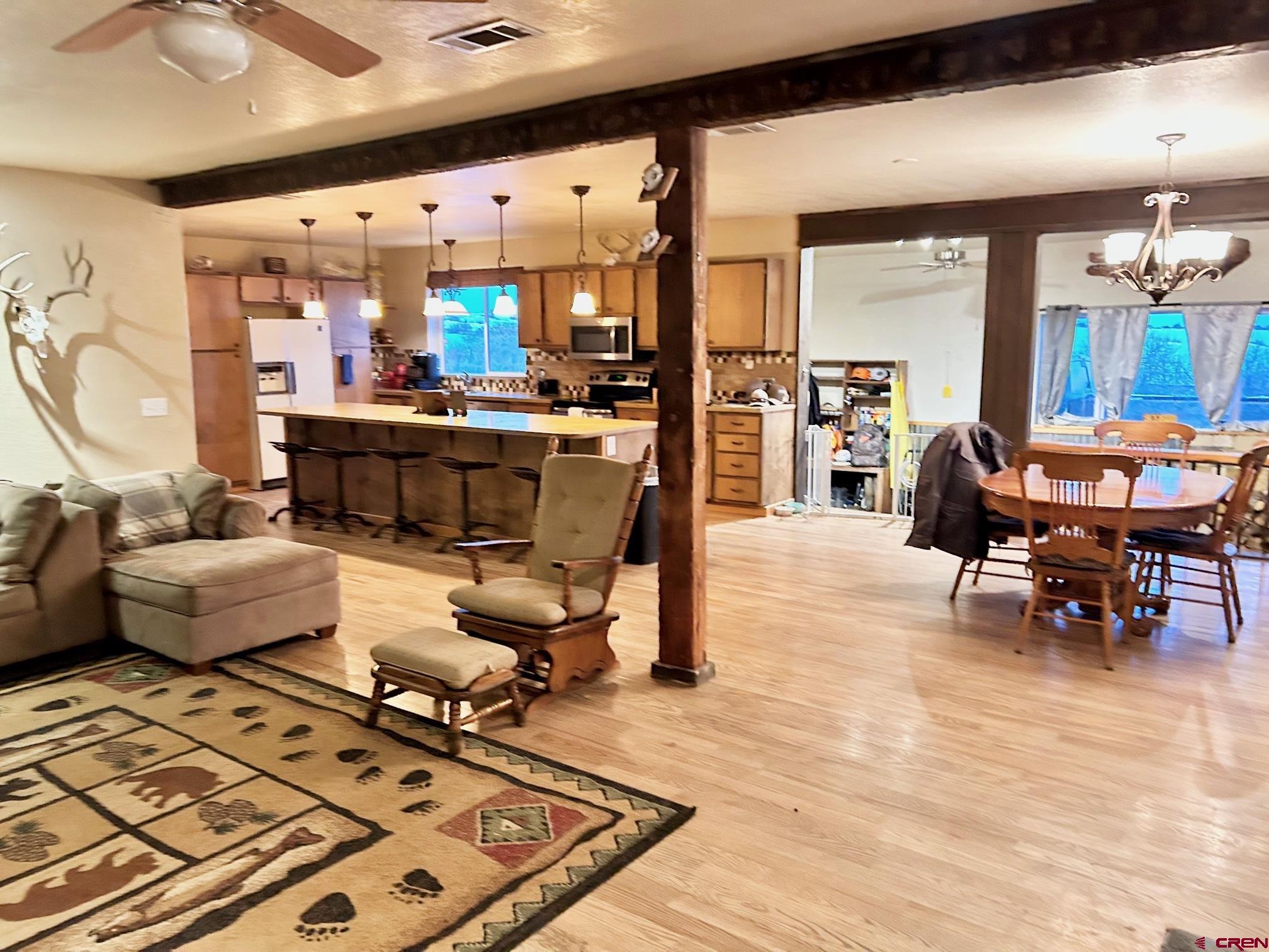 175 County Road Egnar, CO 81325 - Photo 11 of 35 a living room with furniture and a dining table with wooden floor
