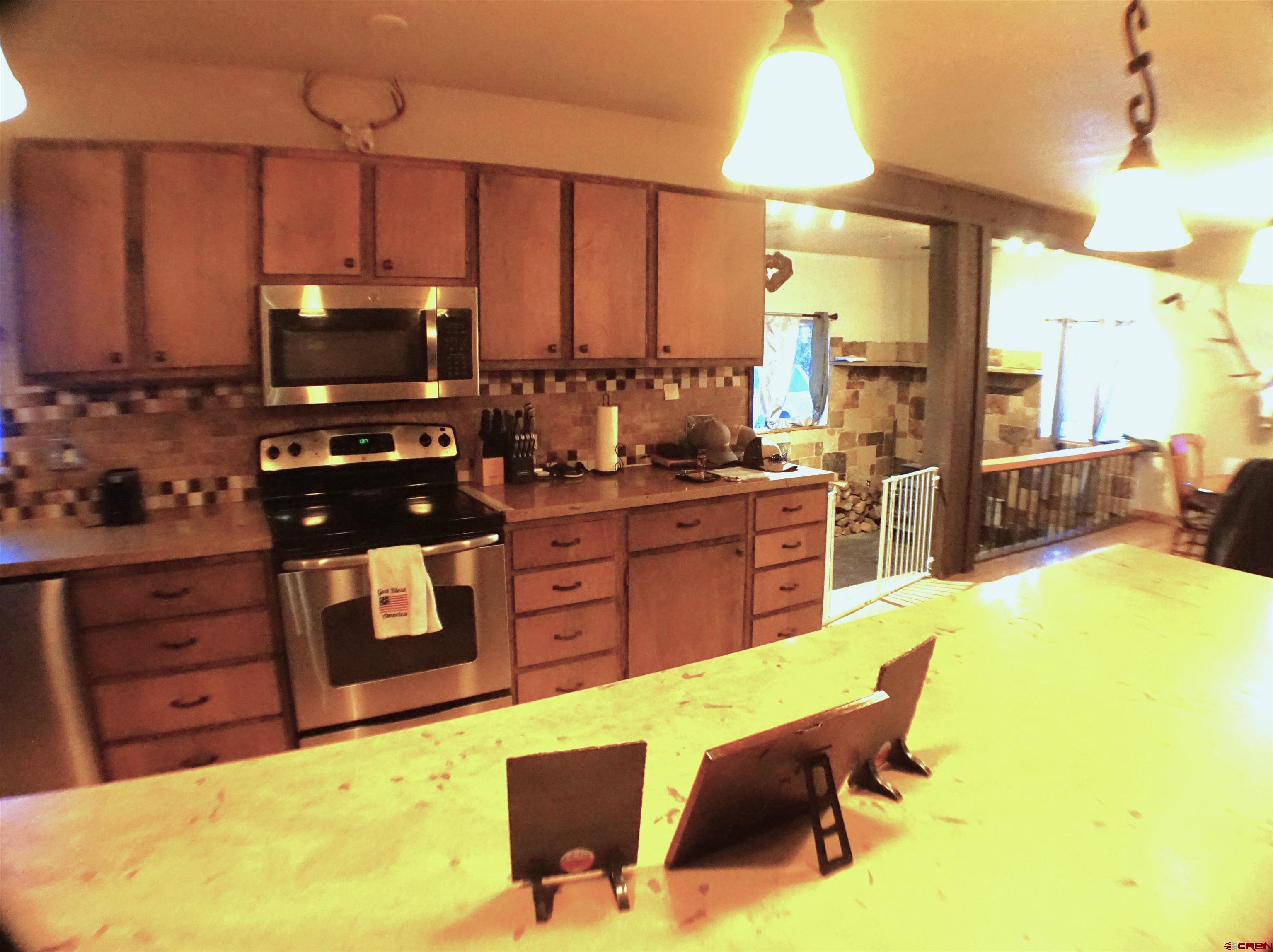 175 County Road Egnar, CO 81325 - Photo 13 of 35 a kitchen with a stove a sink and a refrigerator
