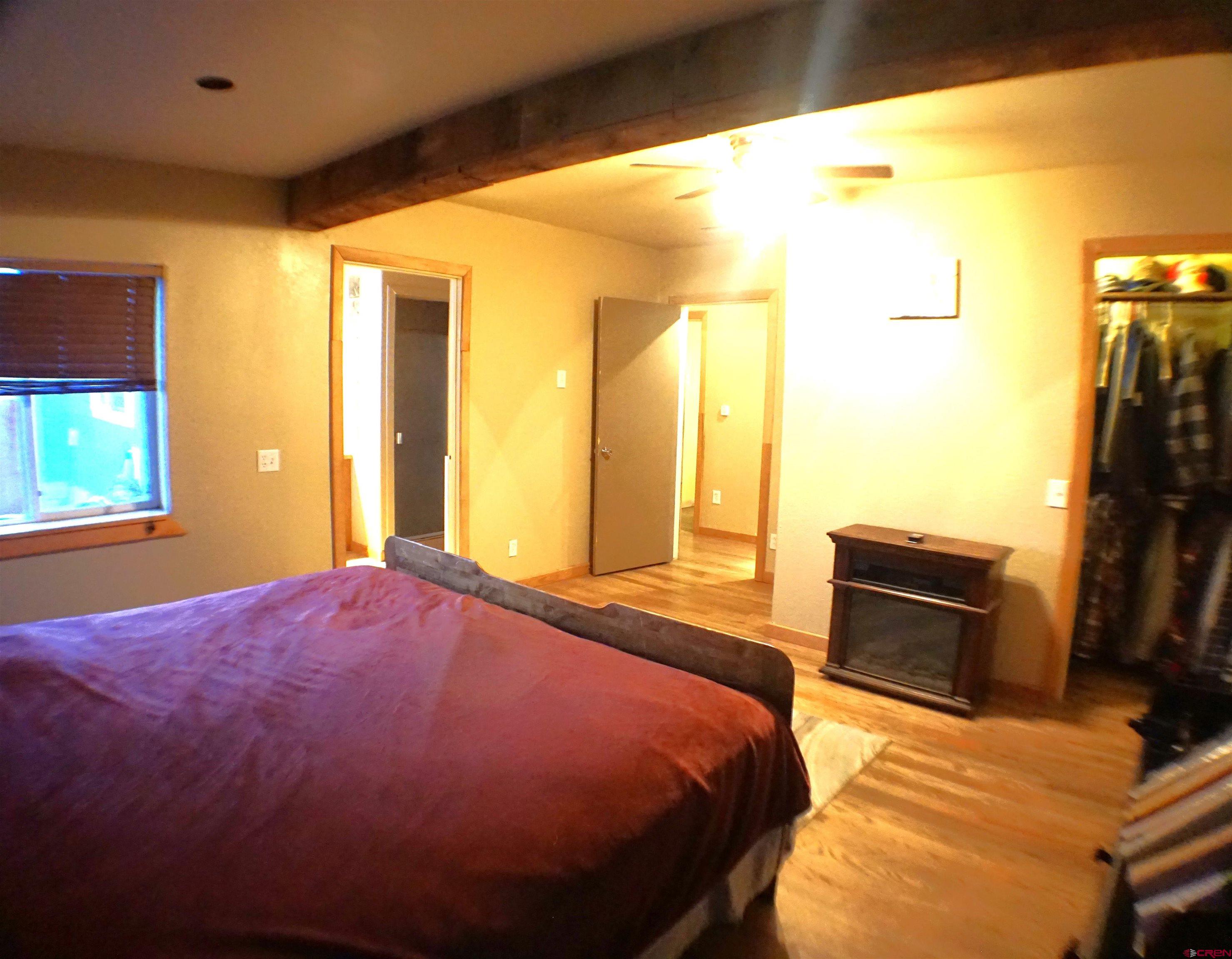 175 County Road Egnar, CO 81325 - Photo 17 of 35 a bedroom with a bed and wooden floor