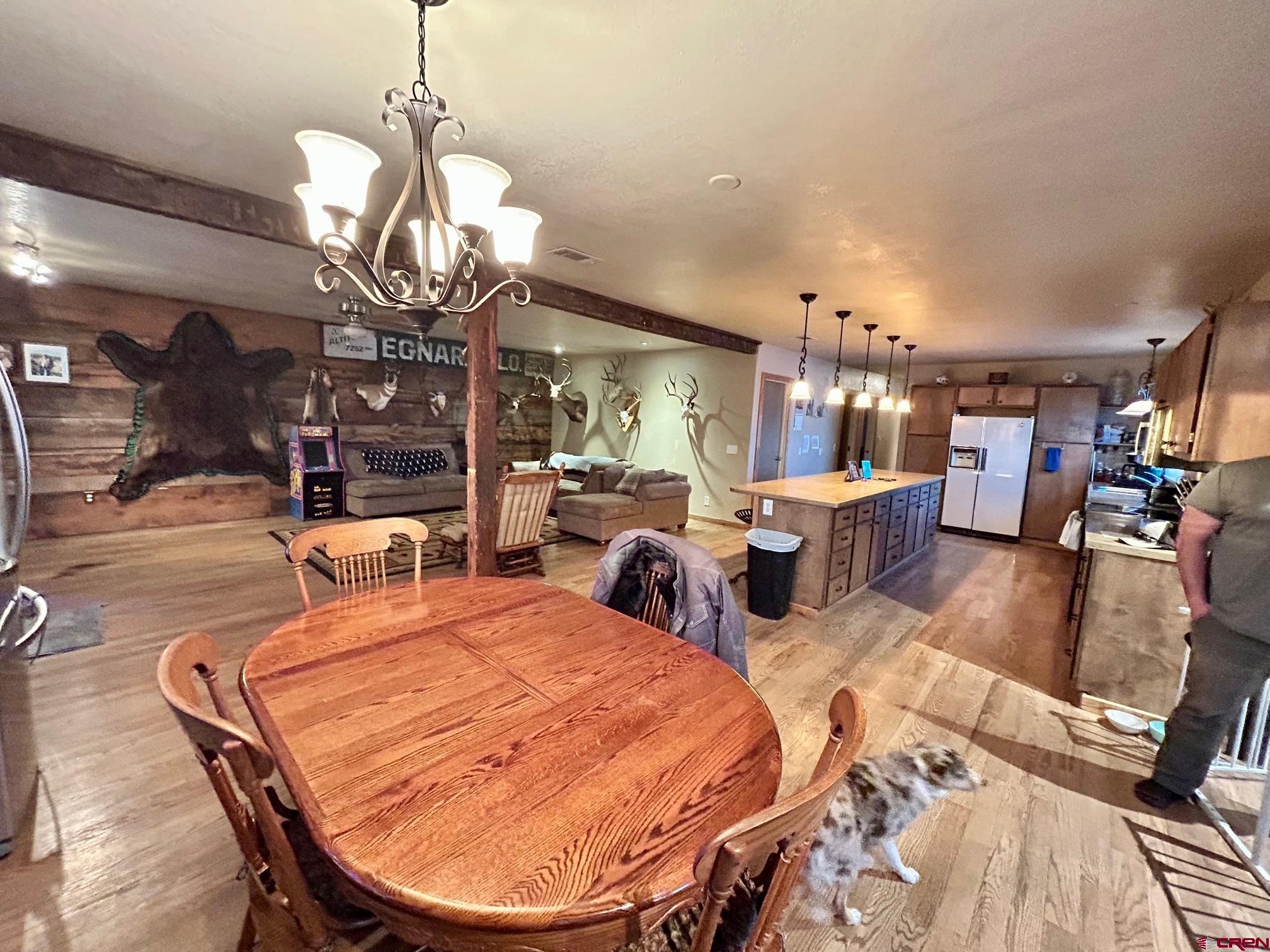 175 County Road Egnar, CO 81325 - Photo 9 of 35 a living room with lots of chairs and a chandelier