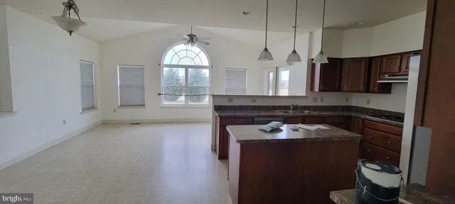 a kitchen with a sink appliances and cabinets