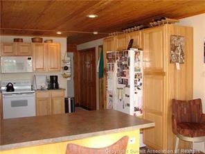 3260 High Creek Road Fairplay, CO 80440 - Photo 3 of 12 a kitchen with a refrigerator and a stove top oven
