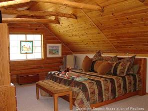 3260 High Creek Road Fairplay, CO 80440 - Photo 7 of 12 a bedroom with a bed and wooden floor