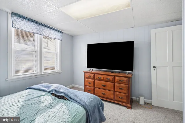 a bathroom with a toilet a sink and a window