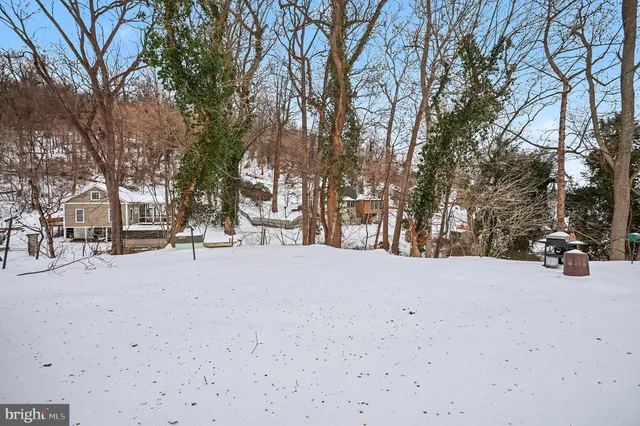 a kitchen with stainless steel appliances granite countertop a stove a sink dishwasher a refrigerator and a stove with wooden floor