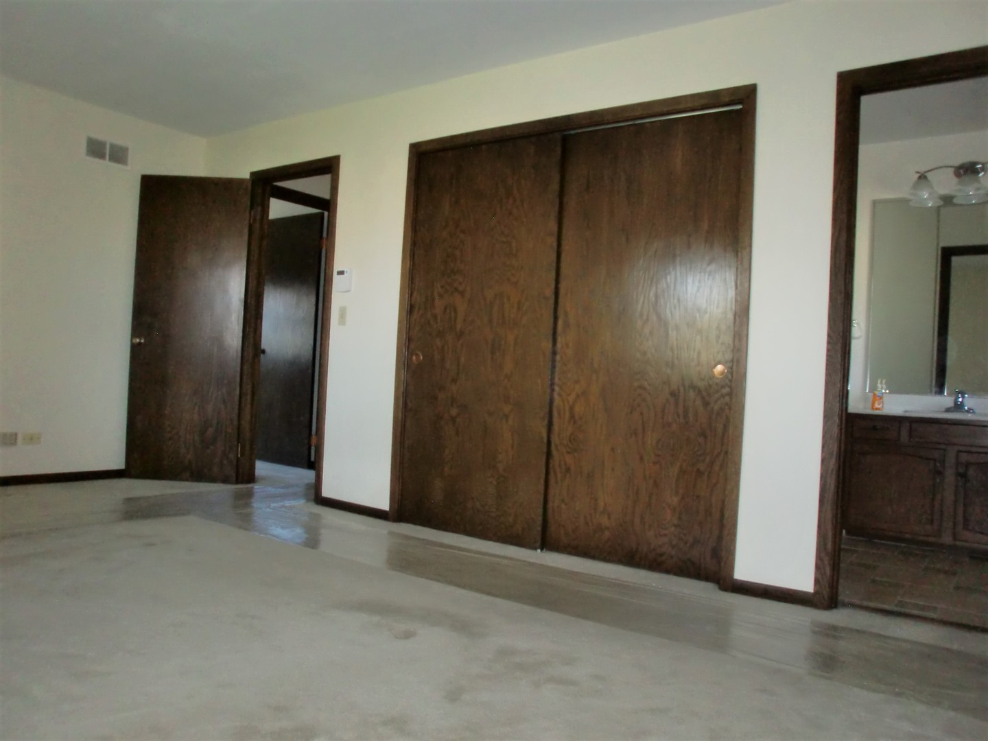 701 Ridge Court Schaumburg, IL 60193 - Photo 15 of 24 an empty room with closet and wooden door