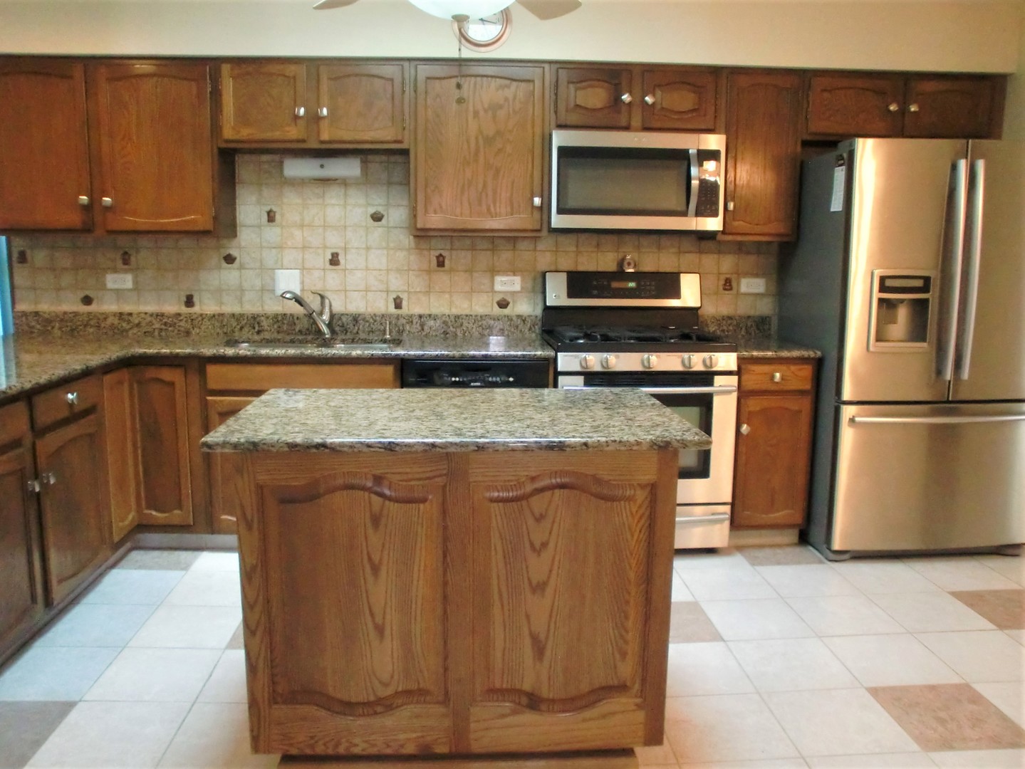 701 Ridge Court Schaumburg, IL 60193 - Photo 8 of 24 a kitchen with stainless steel appliances granite countertop a stove a sink dishwasher and a refrigerator