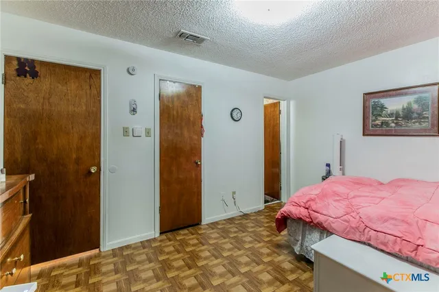 a bedroom with a bed and a dresser