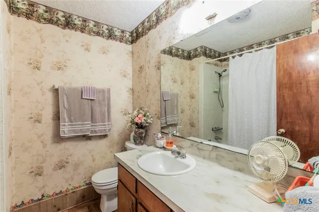 a bathroom with a shower and a shower curtain