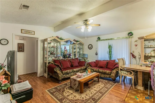 a living room with furniture a table and a flat screen tv