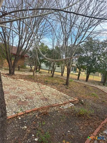a backyard of a house with table and chairs
