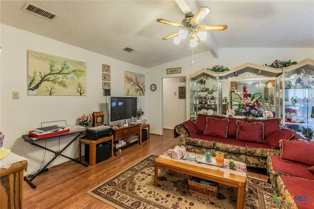a living room with furniture a rug and a flat screen tv