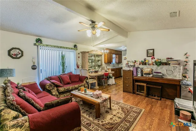 a living room with furniture a rug and a chandelier