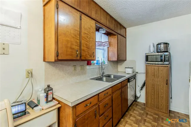 a kitchen with stainless steel appliances granite countertop a sink stove and cabinets