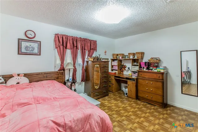 a bedroom with a bed and furniture