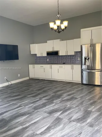 a kitchen with stainless steel appliances granite countertop a granite counter tops and a refrigerator