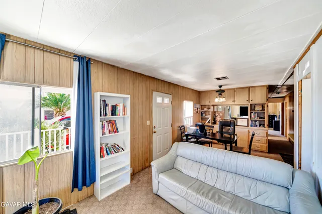 a living room with furniture and a bookshelf