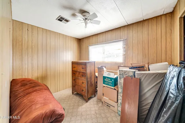 a view of a bedroom with furniture and windows
