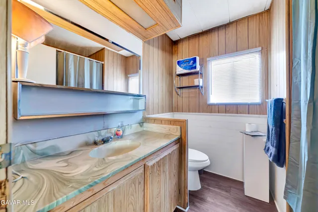 a bathroom with a sink toilet and a mirror