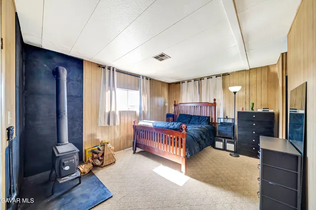 a bedroom with furniture and a window