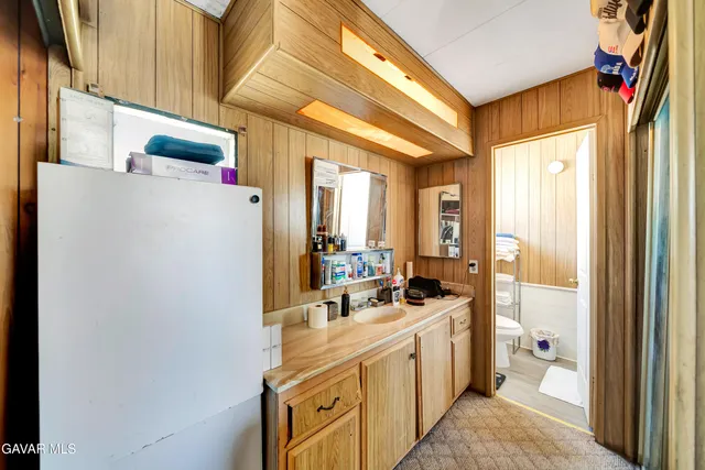 a bathroom with a sink a mirror and a shower