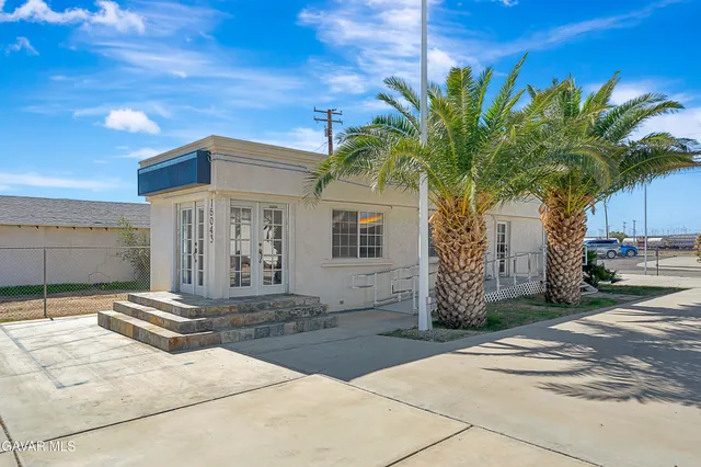 a front view of a house with tree s