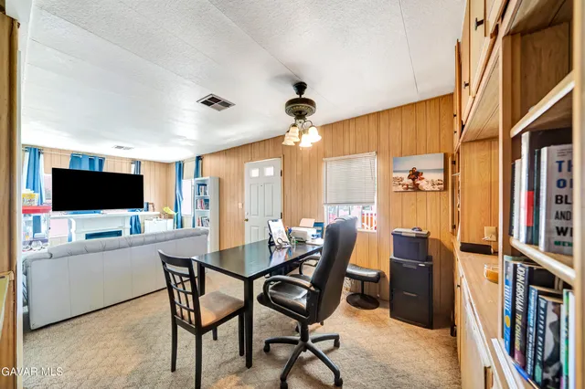 a view of a livingroom with furniture and a flat screen tv