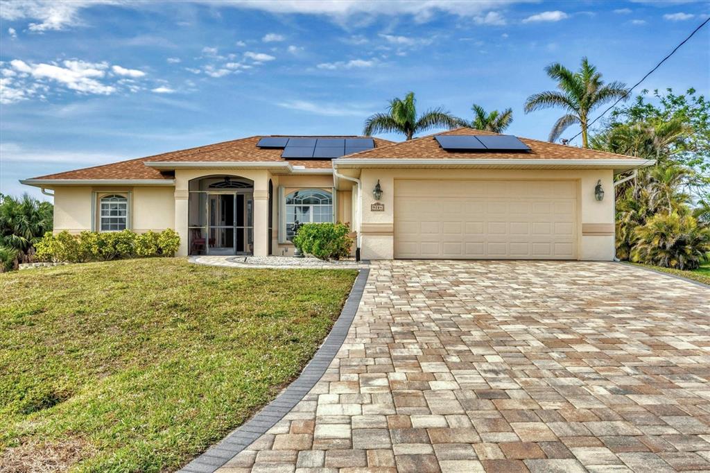 9214 Snapper Circle Port Charlotte, FL 33981 - Photo 1 of 1 a front view of a house with a garden