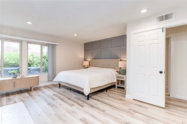 a spacious bedroom with a bed and a view of bathroom
