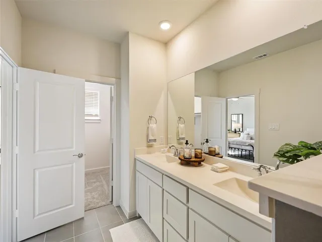 a bathroom with a double vanity sink mirror and toilet