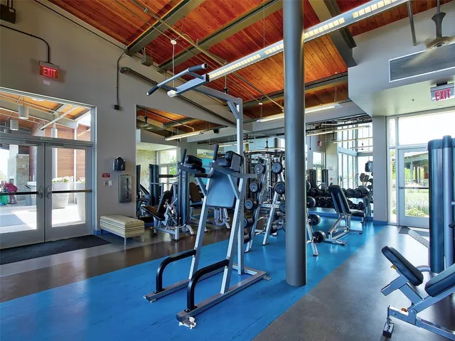 a gym room with lots of chairs and a table