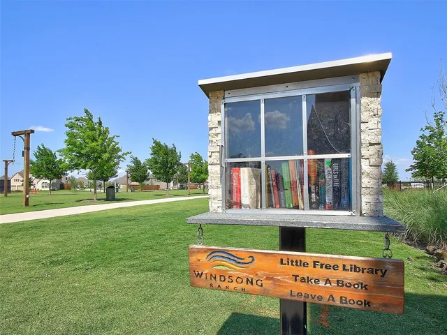a view of a patio with a table and chairs under an umbrella