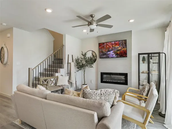 a view of a dining room with furniture a fireplace and wooden floor