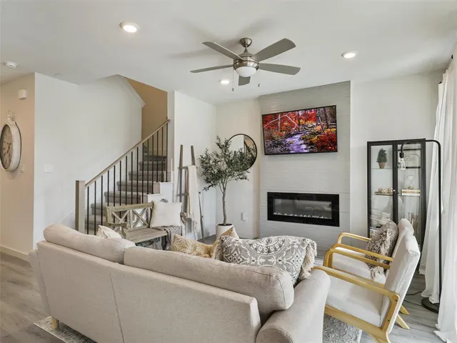 a view of a dining room with furniture a fireplace and wooden floor