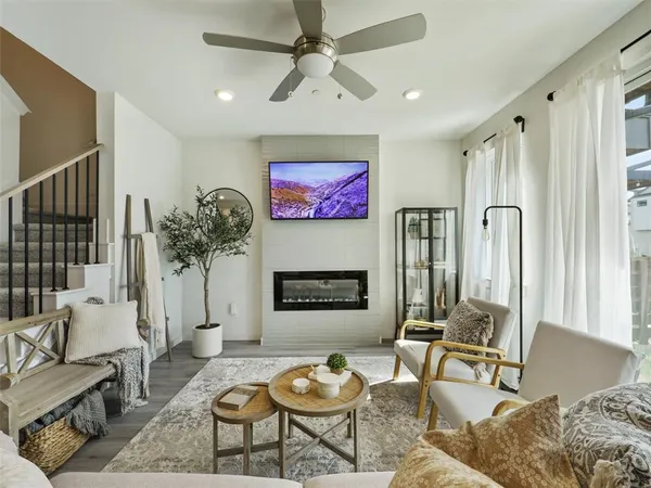 a living room with furniture a fireplace and a flat screen tv