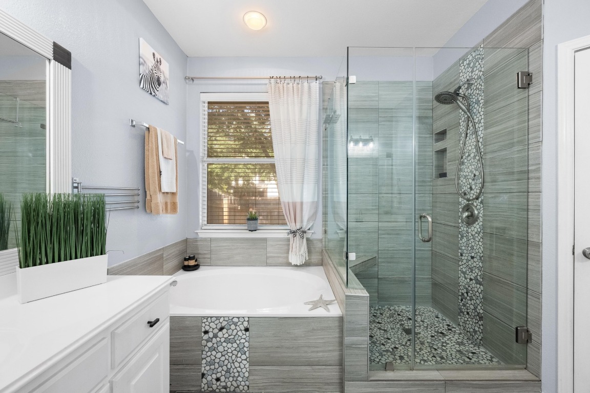 12201 Barrel Bend Austin, TX 78748 - Photo 20 of 35 Bathroom with a bath, a shower stall, and vanity