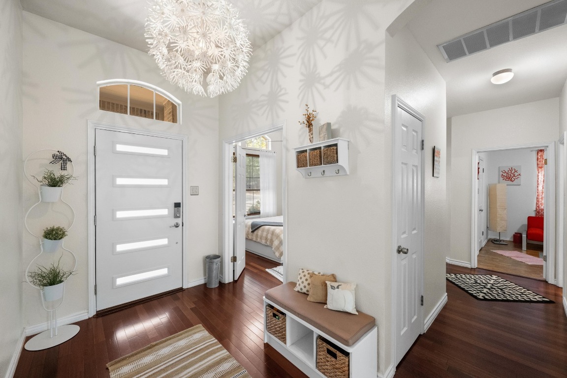 12201 Barrel Bend Austin, TX 78748 - Photo 23 of 35 Entryway with dark wood finished floors and a chandelier